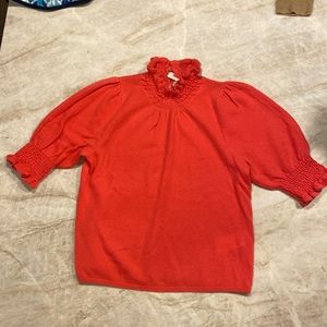 Cashmere sweater.Salmon color with elastic gathered trim around arms and neck.